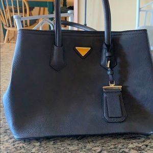 This is a medium handbag with shoulder strap.